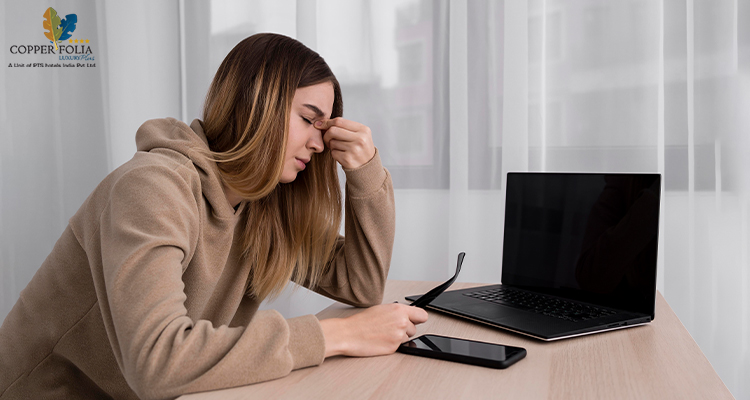 Image of a frustrated woman in front of a laptop