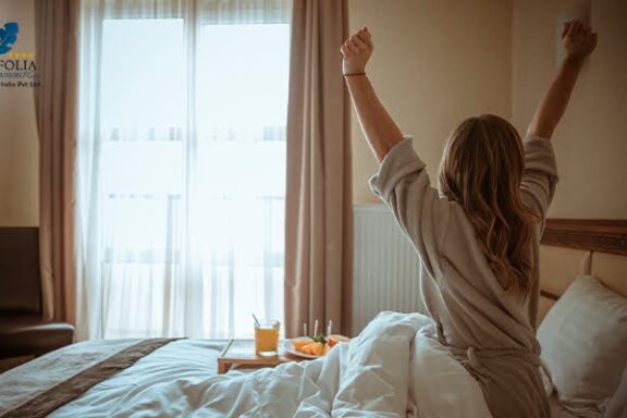 Woman relaxing and waking up in a comfortable hotel room
