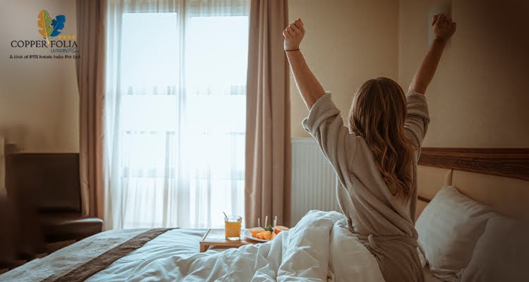 Woman relaxing and waking up in a comfortable hotel room