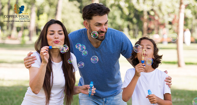 Parents and child enjoying bubble play during hotel activities