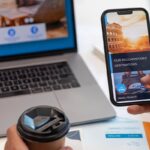 Traveler booking a hotel online using laptop and smartphone