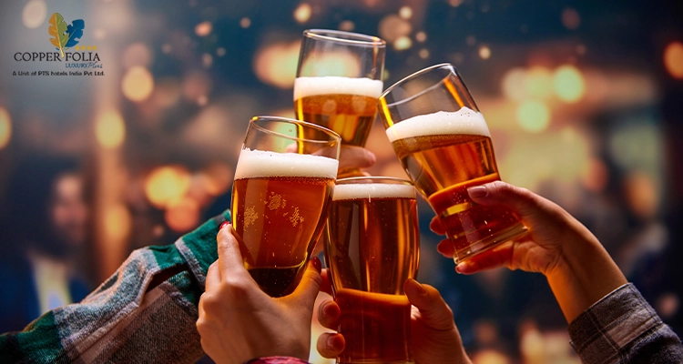 Friends clinking beer glasses and making a cheerful toast