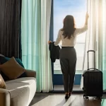 Confident businesswoman relaxing in hotel room near airport