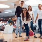 Friends enjoying a fun bowling activity during leisure time