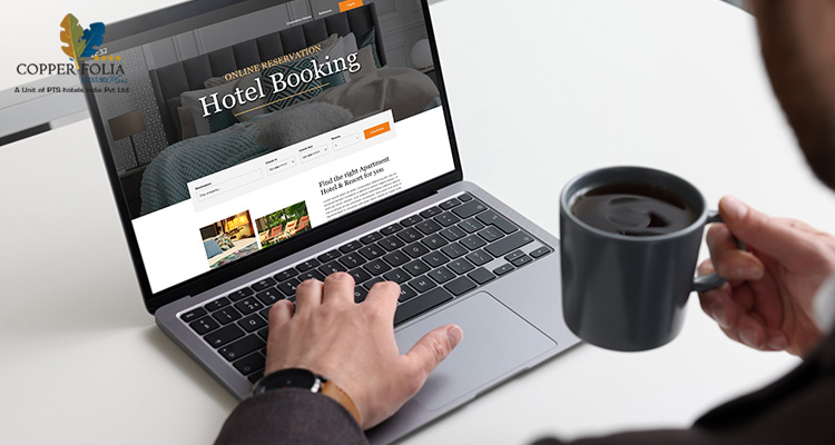 Man booking a hotel in Calicut using laptop at a desk